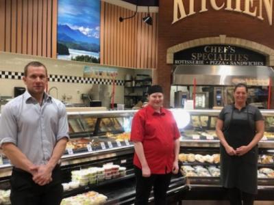 photo of grocery store staff standing with social distancing