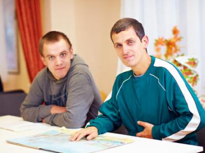 picture of 2 men studying a book