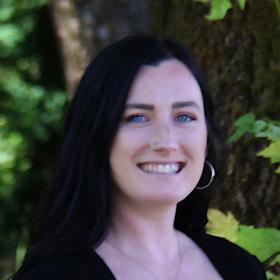 A picture of a woman with a black shirt smiling