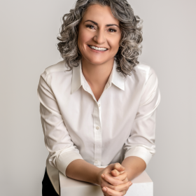 A woman in a white shirt smiling